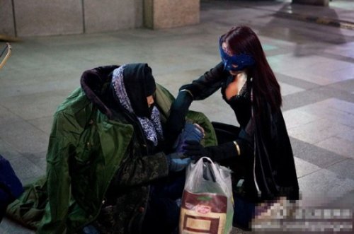 Девушка в костюме супергероя помогает бедным
